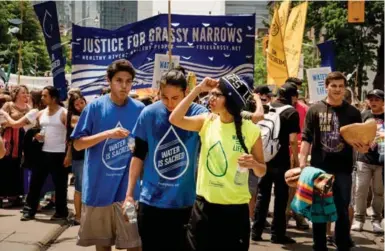  ?? ALLAN LISSNER/FREEGRASSY.NET ?? More than 1,000 people walk in downtown Toronto June 2 to demand the cleanup of mercury-poisoned Grassy Narrows river.