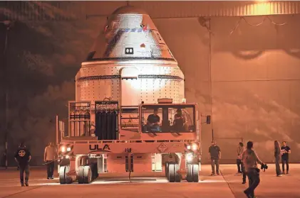  ?? PHOTOS BY CRAIG BAILEY/FLORIDA TODAY ?? Boeing’s Starliner capsule rolls out of its facility at Kennedy Space Center on Tuesday morning. The capsule is being transporte­d to Launch Complex 41 where it will be mated to an Atlas V rocket, scheduled to launch May 6.