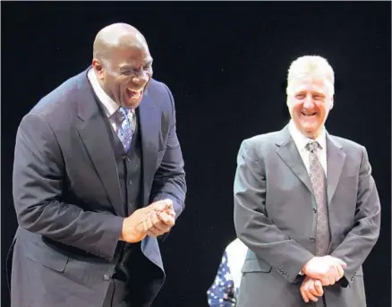  ?? Walter McBride Corbis via Getty Images ?? FIERCE ADVERSARIE­S as players with the Lakers and Celtics in the 1980s, Magic Johnson, left, and Larry Bird ultimately forged a friendship, as was evident at the Broadway opening of the play “Magic/Bird” in 2012. Now they’ll compete again as team...