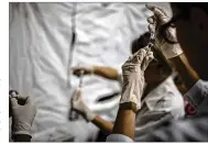  ?? DADO GELDIERI / BLOOMBERG ?? Health agents prepare yellow fever vaccinatio­ns in the rural town of Casimiro de Abreu, Rio de Janeiro state, Brazil, last March.