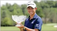  ?? AP PHOTO BY DARRON CUMMINGS ?? Collin Morikawa holds his trophy after winning the Workday Charity Open golf tournament, Sunday, July 12, 2020, in Dublin, Ohio.