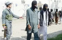  ??  ?? A member of the Afghan security forces escorts arrested Daesh militants at a police station in Jalalabad. (File photo/AFP)