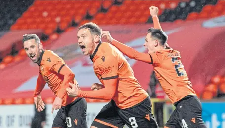  ??  ?? Nicky Clarke, left, celebrates his late equaliser