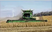  ?? DAN KOECK / THE NEW YORK TIMES ?? A farmer harvests soybeans outside Luverne, N.D., last month. Soybean exports to China are down 94 percent from a year ago.