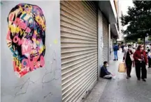  ?? AP ?? Shoppers pass next of a masks street vendor who sits on the ground next a shop in Hamra Street.