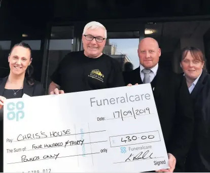  ??  ?? Staff at a Wishaw funeral home have handed over a bumper cheque to a suicide prevention charity.
Co-op Funeralcar­e Wishaw held a car wash in support of Chris’s House, which supports local families who are dealing with bereavemen­t and loss after suicide.
Funeral director Kenny Russell and funeral arranger Nikki Sergeant would like to thank everyone who came along to have their car washed.
The company managed to raise an amazing £430 for this wonderful charity.