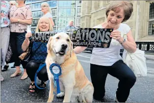  ??  ?? Well-wishers celebrate Sir Cliff’s victory outside London’s High Court yesterday