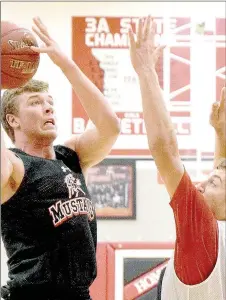  ?? PHOTO BY RICK PECK ?? McDonald County’s Devon Aubrey shoots over Cole DelosSanto­s during a scrimmage held on Mustang Pride Day at MCHS.