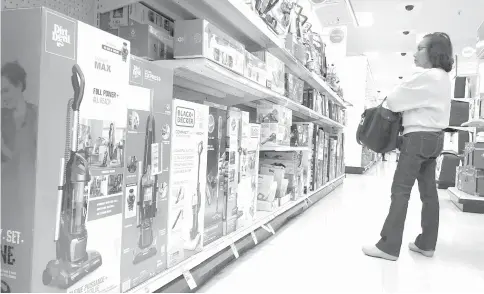  ?? — AFP photo ?? Household vacuum cleaners which were produced in China are lined up for sale in a Target store in Los Angeles.