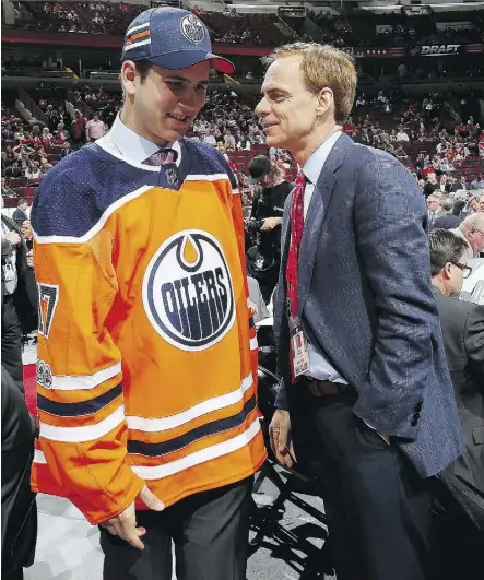  ?? BRUCE BENNETT/GETTY IMAGES ?? Kirill Maksimov, left, talks with Scott Howson, new Edmonton Oilers’ vice-president of player developmen­t, after being selected 146th overall by the Oilers at the NHL entry draft in Chicago.