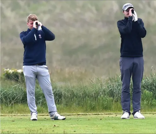  ?? Picture: Colin Bell ?? Smith of Laytown & Bettystown GC measure the distance from the 7th tee box at the East of Ireland Amateur Open in Baltray.