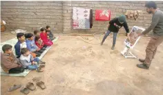  ?? — Reuters ?? Members of the demining team give tutorials to kids on how to avoid mines in Khazer.