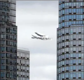  ??  ?? LANDING: Space shuttle Enterprise, riding on the back of the NASA 747 Shuttle Carrier Aircraft, cruises over the Hudson river on Friday in New York. Enterprise is eventually going to make its new home in New York City at the Intrepid Sea, Air and Space...