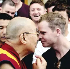  ?? — AFP photo ?? Tibetan Spiritual Leader The Dalai Lama (L) greets Australian touring cricket captain Steve Smith (R) at his residence in Dharamsala on March 24, 2017, ahead of the fourth and final Test cricket match between India and Australia.