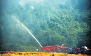  ??  ?? Thousands of gallons of water was used to combat the spread of fire