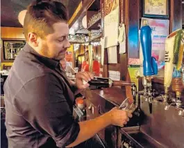  ?? TREVOR FRASER/ORLANDO SENTINEL PHOTOS ?? J.R. Baal, bartender at Fiddler’s Green in Winter Park, pours a Guinness. “It’s about knowing what a proper pint should be and having that respect,” he said.
