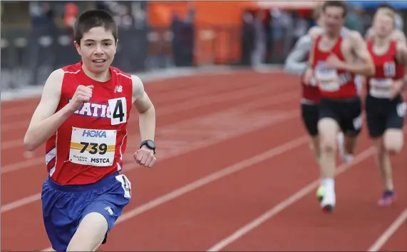  ?? PAUL CONNORS PHOTOS / BOSTON HERALD ?? YOUTHFUL EXUBERANCE: Natick’s Joe Vogel leads the field of runners while racing in the boys’ 2-mile run during the MSTCA Freshman/Sophomore track meet on Saturday. Below, Franklin’s Sarah Dumas clears the final hurdle on her way to a victory in the 400-meter event.