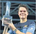  ??  ?? Milos Raonic lifts the Brisbane Internatio­nal trophy.