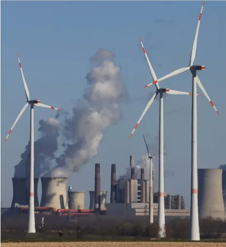  ?? Reuters ?? German energy company RWE’s wind turbines and brown coal-fired power plant near Cologne. The introducti­on of wind power has prevented the release of about 830 million tonnes of carbon dioxide since 2019, according to the Internatio­nal Energy Agency