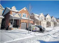  ?? REUTERS/MARK BLINCH ?? A real estate for sale sign stands in front of a house in East Gwillimbur­y, Ont., on Jan. 30, 2018.