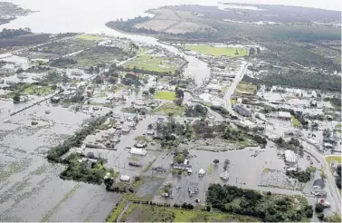  ?? STEVE HELBER/AP ?? Flood waters from Hurricane Florence inundate the town of Engelhard, N.C., on Saturday. Rescues took on greater urgency as flood zones grew. Thousands more people were ordered evacuated.