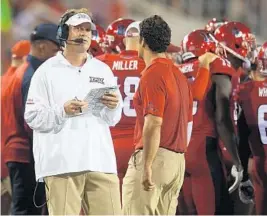  ?? JIM RASSOL/STAFF FILE PHOTO ?? Head coach Lane Kiffin, left, is trying to make the transition with new coordinato­rs a smooth one by letting them bring in their own philosophi­es.