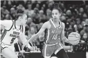  ?? KEN BLAZE USA TODAY NETWORK ?? Guard Aziaha James, seen here trying to dribble by South Carolina guard Tessa Johnson, scored 20 points for NC State but it wasn’t enough for the Wolfpack, who were in the Final Four for just the second time.