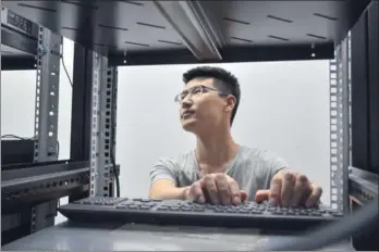  ?? PROVIDED TO CHINA DAILY ?? An engineer from G-Net Cloud Services Co checks on-site communicat­ion equipment at one of the company’s clients in Jakarta in June.