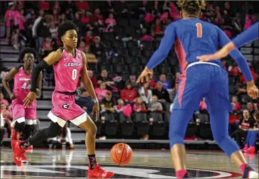  ?? SAVANNAH COLE / SPECIAL TO THE AJC ?? Georgia’s Taja Cole brings the ball up the court against the Florida Gators at Stegeman Coliseum on Sunday. Cole had 14 points and a career-high 12 assists in Georgia’s 93-58 victory.