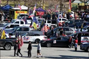  ??  ?? Supporters of President Donald Trump prepare to take their caravan along the Rose Bowl parade route Friday in Pasadena, Calif. Several other groups also carried on with car cruises along the route.
(AP/The Orange County Register/Keith Birmingham)