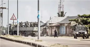  ??  ?? A truck transporti­ng Tanzanian Army personnel is seen in Daraja Bovu, Zanzibar, near the Mtupepo polling station where Hamad has been arrested. — AFP photo