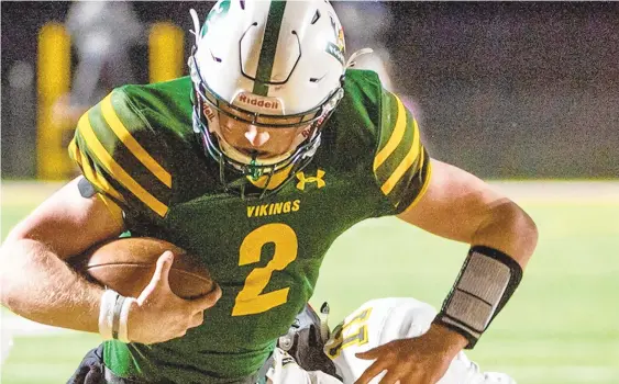  ?? APRILGAMIZ/THE MORNING CALL ?? Central Catholic’s QB Matt Rauscher (2) runs in a touchdown against Northweste­rn Lehigh’s Reed Conrey (11) during a District 11 Class 4A football final held Thursday at Whitehall’s Zephyr Stadium.