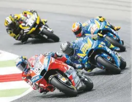  ??  ?? Dovi holds off the challenge of hard-riding former team-mate Iannone