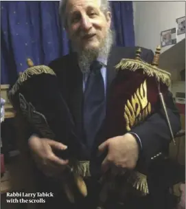  ??  ?? Rabbi Larry Tabick with the scrolls