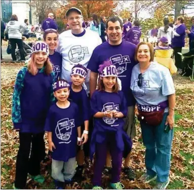  ?? SUBMITTED PHOTO ?? Walking in the fight against pancreatic cancer are Fred Loomis in white shirt, wife Chris Loomis, far right; son Mark Loomis, in purple shirt, and his daughters, Kaitlyn and Audrey Loomis; Jennifer Kennedy, standing next to Fred, and Kennedy’s sons Kyle and Tyler Kennedy