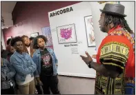  ?? Arts & Science Center for Southeast Arkansas/SHANNON FRAZEUR ?? Kevin Cole (right) speaks to Pine Bluff High School art students about the AfriCOBRA art collective Oct. 18 at the Arts &amp; Science Center for Southeast Arkansas.