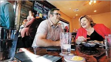  ?? LUIS SINCO/LOS ANGELES TIMES ?? Freeman Barlow, left, a candidate for the city council of Colorado City, Ariz., meets with Donia Jessup, the mayor of nearby Hildale, Utah, at the Edge of the World Brewery and Pub, which opened last year.