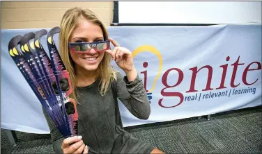  ?? NWA Democrat-Gazette/BEN GOFF • @NWABENGOFF ?? Hailey Brown, a Bentonvill­e High senior, poses with solar eclipse viewing glasses Friday at Bentonvill­e West High in Centerton. Brown, a second-year student in the Bentonvill­e Public Schools Ignite digital design program, designed the graphics on the...