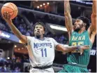  ?? COMMERCIAL APPEAL ?? Memphis guard Malik Rhodes (left) drives for a layup against Siena defender Nico Clareth in Memphis on Dec. 20, 2017. MARK WEBER/THE
