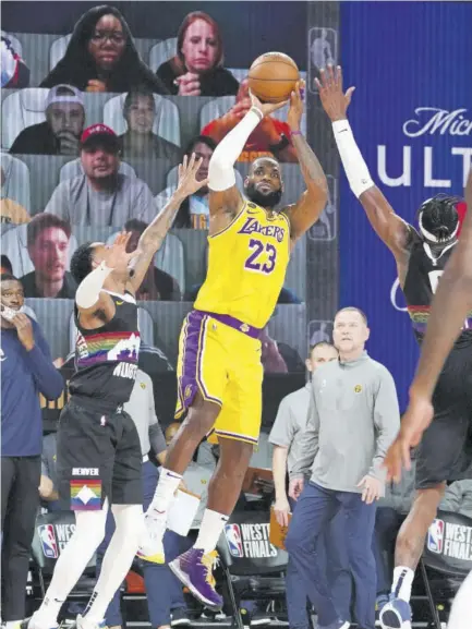  ?? (Photo: AFP) ?? Lebron James (centre) of the Los Angeles Lakers shoots the ball against the Denver Nuggets during game four of the Western Conference finals of the NBA Play-offs on Thursday.