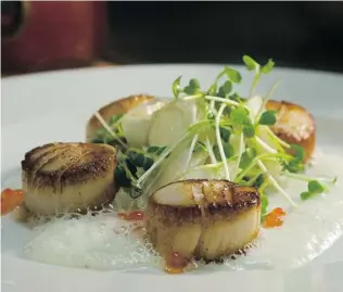  ??  ?? Seared scallops and similar mouth- watering fare can be found throughout B. C.