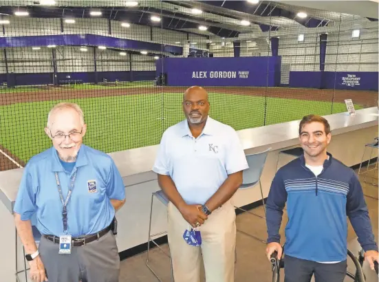  ?? JOE MOCK ?? The indoor portion of the Kansas City Urban Youth Academy includes a full-size infield. Academy executive director Darwin Pennye is shown at center. At left is Morrie Carlson, manager of tours at Kauffman Stadium and a volunteer in the academy’s mentoring program. At right is Jonathan Rosa, the academy’s assistant to baseball operations.