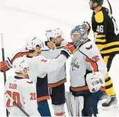  ?? MICHAEL DWYER/AP ?? Washington Capitals’ Darcy Kuemper (35) celebrates with teammates as Boston Bruins’ David Krejci (46) skates off the ice after the Capitals defeated the Bruins on Saturday in Boston.