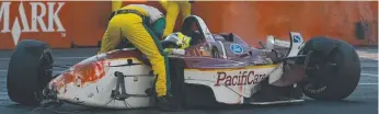  ??  ?? A concerned track official checks on a driver after one of many crashes in the rain-swept 2003 race.