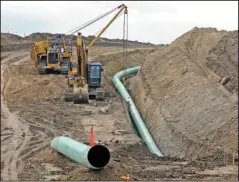  ?? The Associated Press ?? PIPELINE: In this Oct. 5, 2016, file photo, heavy equipment is seen at a site where sections of the Dakota Access pipeline were being buried near the town of St. Anthony in Morton County, N.D. A federal judge on Monday, sided with the Standing Rock Sioux Tribe and ordered the Dakota Access pipeline to shut down until more environmen­tal review is done.