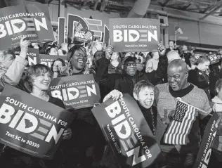  ?? Maddie McGarvey / New York Times ?? Supporters of former Vice President Joe Biden cheer early returns from the South Carolina Democratic primary on Saturday in Columbia, S.C. Black voters gave Biden a decisive victory.