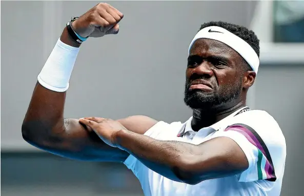  ?? GETTY IMAGES ?? American Frances Tiafoe flexes his bicep to celebrate his upset win over fifth seed Kevin Anderson in the Australian Open yesterday.