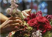  ?? Jon Shapley / Staff photograph­er ?? Stephen-Louis Ralston, a floral designer, works on an arrangemen­t Thursday at David Brown Flowers.