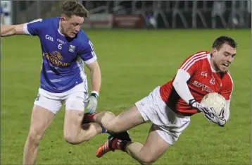  ??  ?? William Woods goes to ground under a challenge from Cavan’s Ciaran Brady.