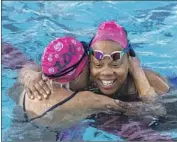  ?? ?? “MIGHTY MO,” one of America’s most decorated masters swimmers, hugs teammate Tanisha Graves.